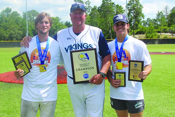 St. Johns River State College baseball coach Ross Jones poses with tournament Most Outstanding Player Ben Barrow (left) and Most Outstanding Pitcher Payton Waters after the Vikings won the FCSAA Region 8 Division II baseball championship game over South Florida State, 11-8, Sunday in New Port Richey. (MARK BLUMENTHAL / Palatka Daily News)