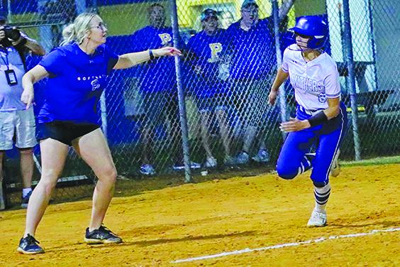 Palatka Junior-Senior High School softball coach Katelynn Smith waves Abbie Huerta around third base to score the first Panthers run of the game in a seven-run fourth inning against Bradford Tuesday night. (RITA FULLERTON / Special to the Daily News)