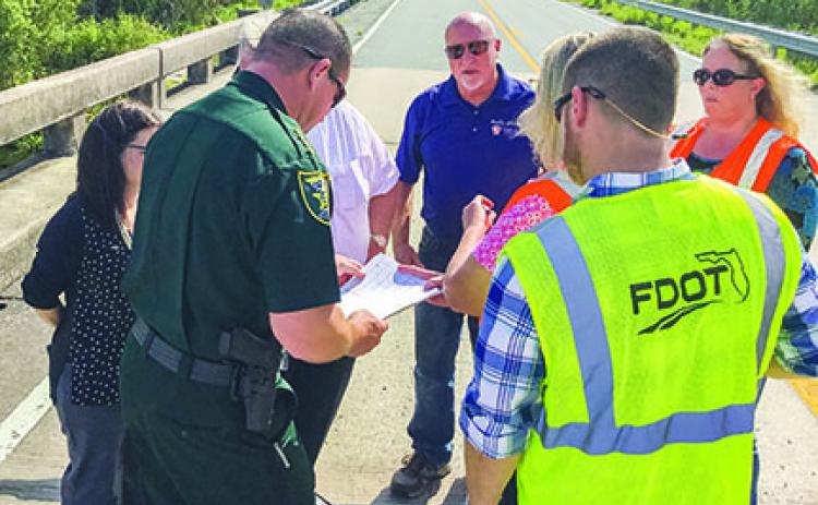 State and county officials discuss the condition of local bridges. 