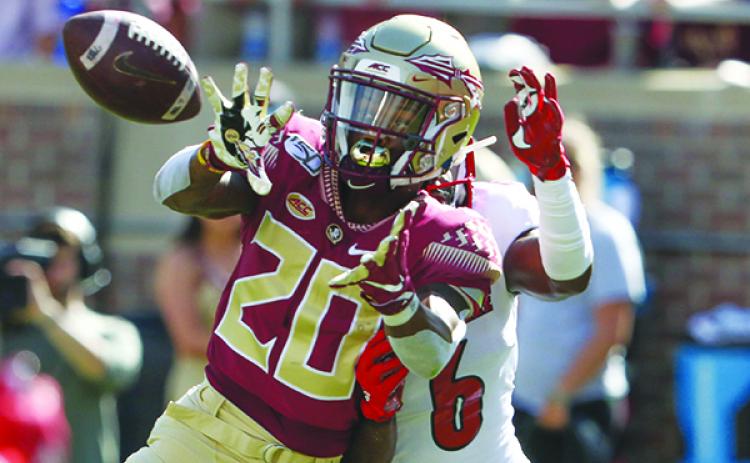 FSU’s Keyshawn Helton comes up with a pass against Louisville. (GREG OYSTER / Special To The Daily News)