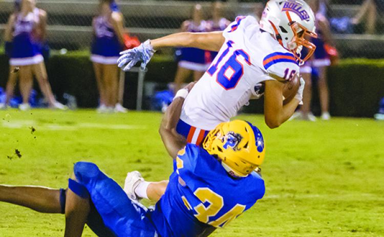 Palatka High junior David Williams wraps up Bolles sophomore Landen Frazier in the second quarter of their game Friday night.  (FRAN RUCHALSKI / Palatka Daily News)