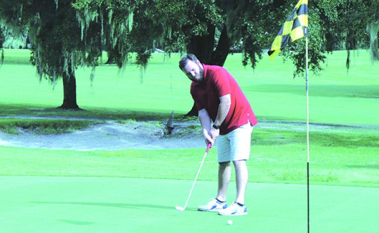 Phillip Harper of Palatka tries to sink a putt during his round at Palatka Municipal Golf Club Tuesday. (MARK BLUMENTHAL / Palatka Daily News)