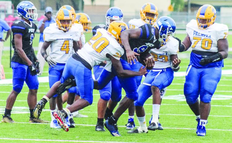 Palatka High School defenders do their best to stop Gainesville P.K. Yonge’s Aaron Small Jr. during the preseason game between the teams last year. (Daily News file photo)