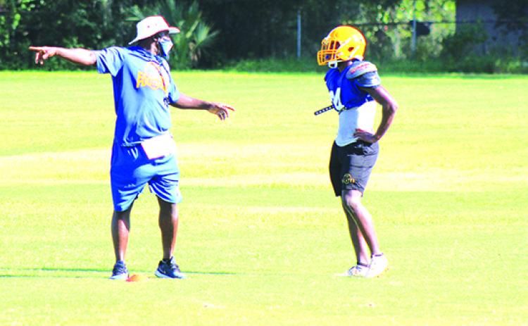 Palatka High School football coach Willie Fells shows Kamari Cohens where to go on kickoff coverage during Wednesday’s practice. (MARK BLUMENTHAL / Palatka Daily News)