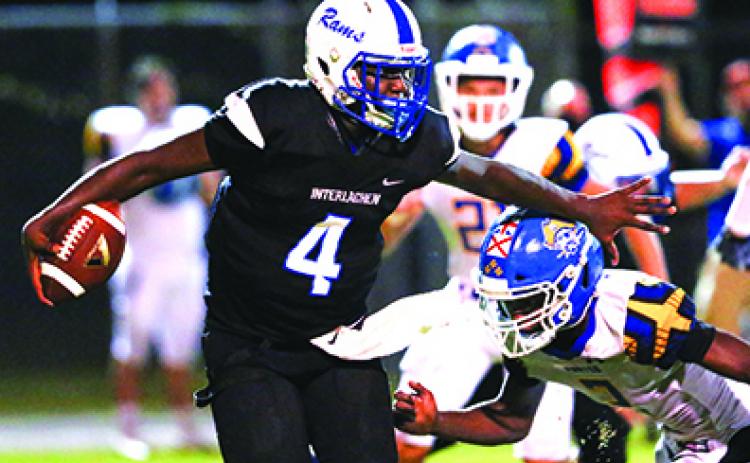 Interlachen High School quarterback Reggie Allen Jr. tries to avoid the tackle of Fernandina Beach’s Sincere Rogers during Friday night’s game. (GREG OYSTER / Special To The Daily News)