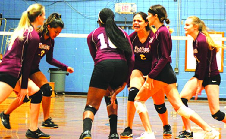 Crescent City High School volleyball players celebrate a service ace during a September match against Peniel Baptist Academy. The Raiders host Trenton High in tonight’s Region 4-1A tournament semifinal. (MARK BLUMENTHAL / Palatka Daily News)