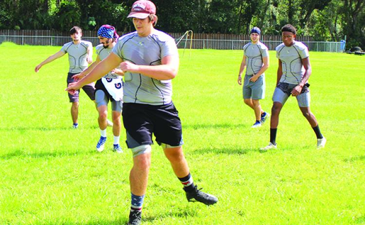 Aiden Sullivan leads his Peniel Baptist Academy six-man football team through exercise drills during practice last month. The Warriors host Gainesville Christian tonight at Theobold Sports Complex. (MARK BLUMENTHAL / Palatka Daily News)