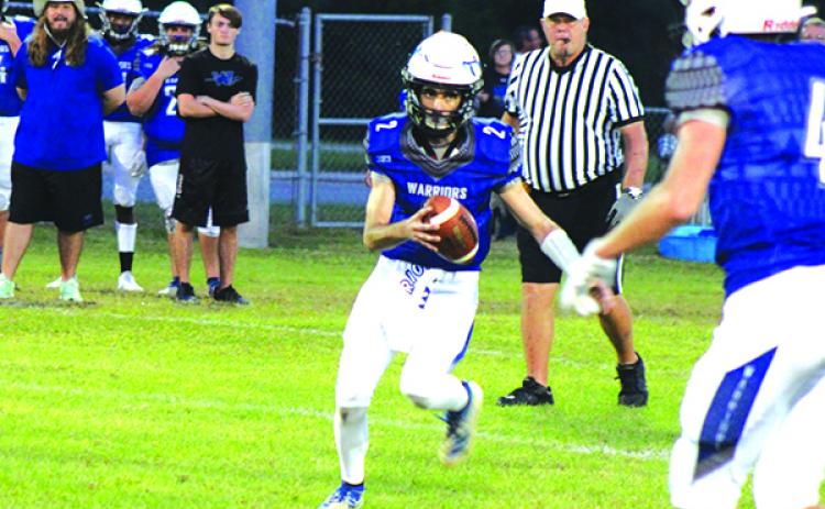 Peniel Baptist Academy quarterback Lucas Chapman scrambles to score on a 10-yard touchdown in the first quarter of Friday night’s game against Gainesville Christian at Theobold Sports Complex. (MARK BLUMENTHAL / Palatka Daily News