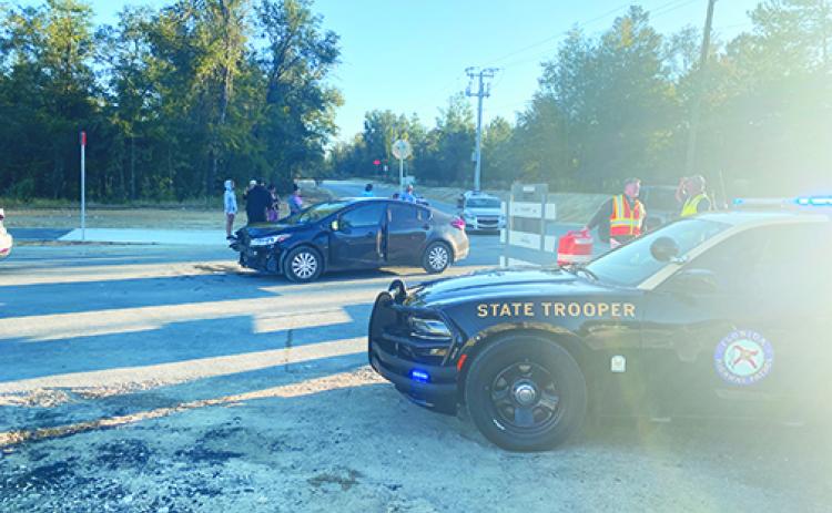 Florida Highway Patrol troopers stay at Lady Slipper Lake Road in Interlachen after a crash Friday at the intersection of State Road 20.