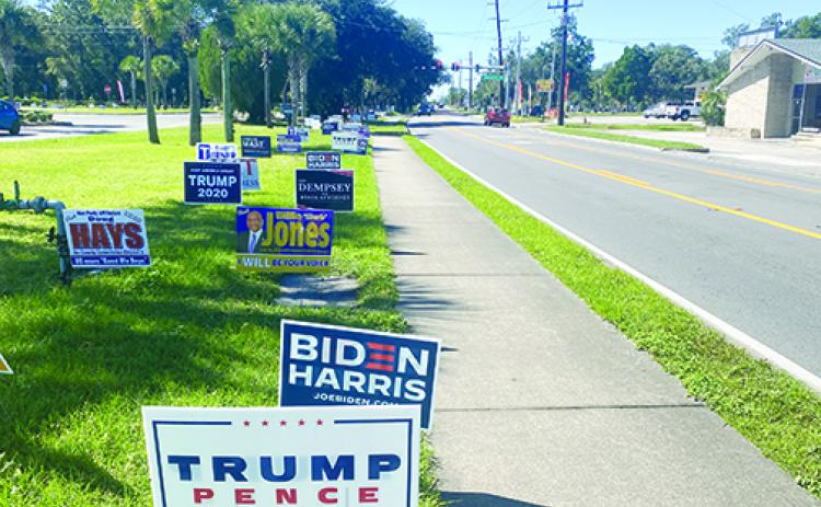 Campaign signs line the lawn in front of the Elections Office in Palatka on Friday, the penultimate day of early voting.