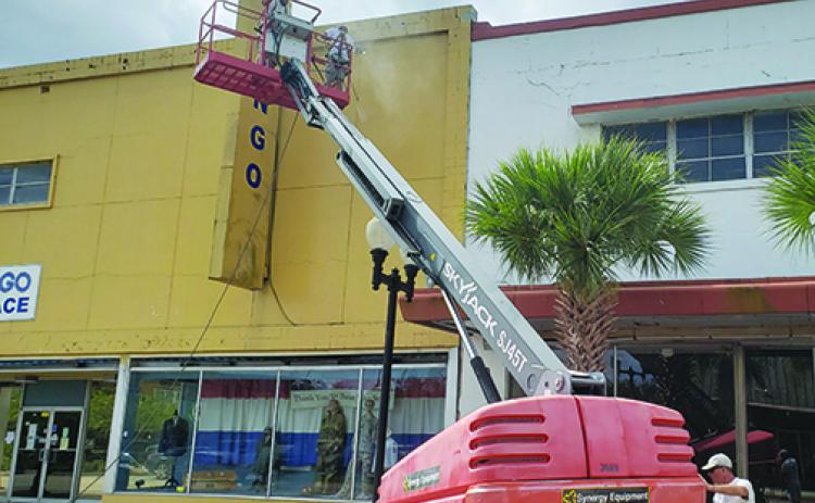 Workers prepare the old JCPenney building in downtown Palatka for a new coat of paint.