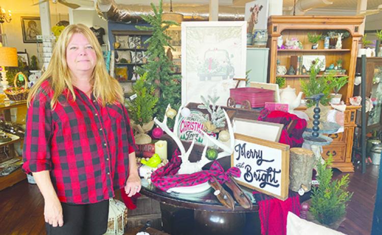 Urban Farmhouse Owner Sherri Granger stands by one of the Christmas displays in her 701 St. Johns Ave. store on Friday.