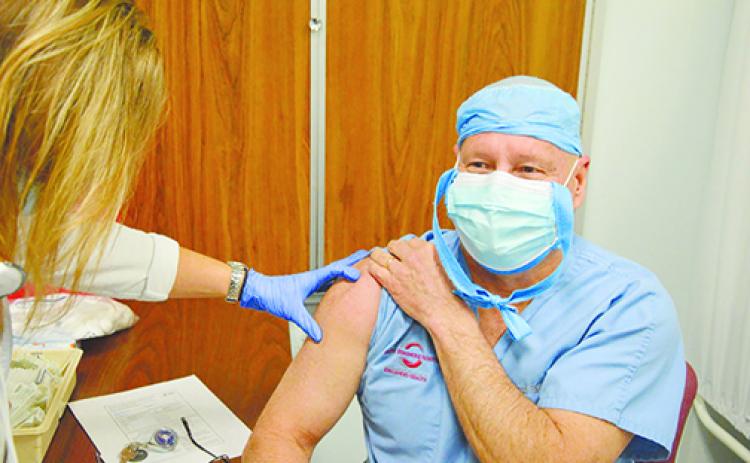 Dr. Richard Feibelman receives his first dose of the COVID-19 vaccine last month at Putnam Community Medical Center.