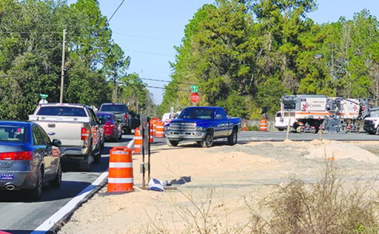 Crews direct traffic Friday as the opening of a portion of the new Dunns Creek Bridge causes traffic jams along detour routes.