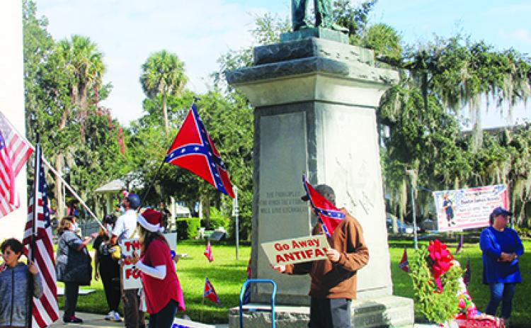 Protesters advocate for the Confederate statue remaining on the Putnam County Courthouse lawn during a protest Saturday at the courthouse.