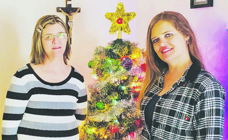 Heather Betliskey, right, stands next to her mother, Carol Cunningham, by their Christmas tree 31 years after Heather received a heart transplant at the age of 2. 