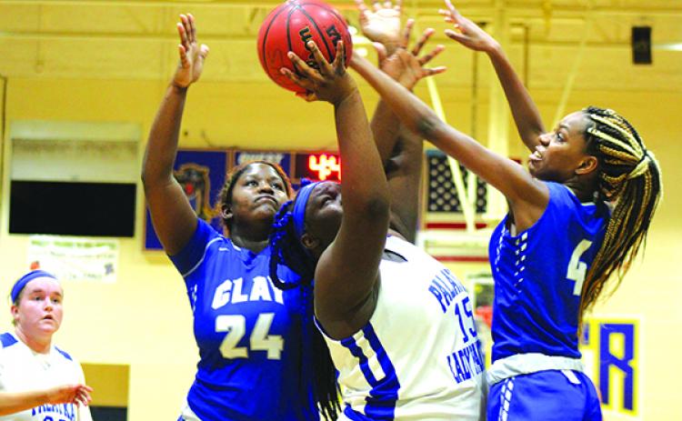 Palatka’s Torryance Poole goes up for a shot against Clay’s Mackenzie White (24) and Jaida Griner in Thursday night’s game. (MARK BLUMENTHAL / Palatka Daily News)