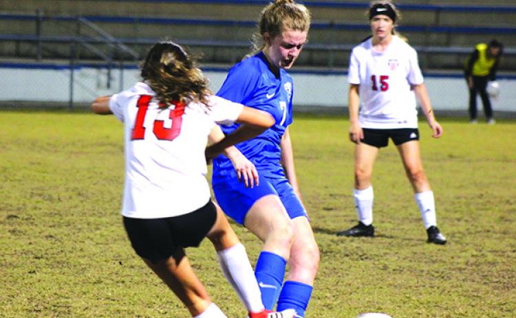 Palatka’s Mattie Smith tries to get the ball away, while being defended by Baker County’s Savannah Pelfrey during Friday night’s game at Cooper-Bennett Field at Veterans Stadium. (MARK BLUMENTHAL / Palatka Daily News)