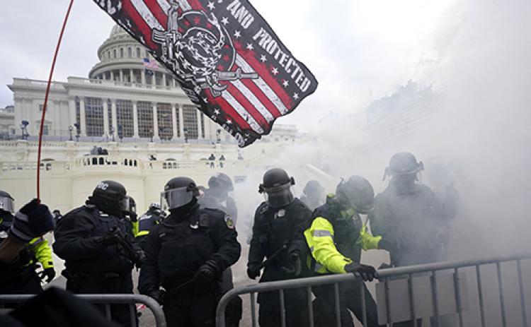 Police hold off President Donald Trump supporters who tried to break through a police barrier Wednesday at the Capitol in Washington. As Congress prepared to affirm President-elect Joe Biden’s victory, thousands of people gathered to show their support for Trump and his claims of election fraud.