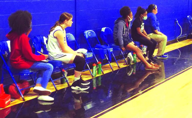 The Interlachen High School’s girls basketball team has just one substitute player and a number of empty seats as Rams coach Kim Troiano (far right) watches the action Thursday night against Orange Park Ridgeview. (MARK BLUMENTHAL / Palatka Daily News)