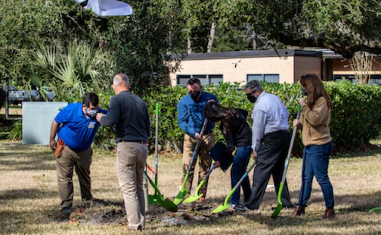 Local officials plant a new live oak Friday to celebrate Arbor Day at St. Johns River State College in Palatka. 