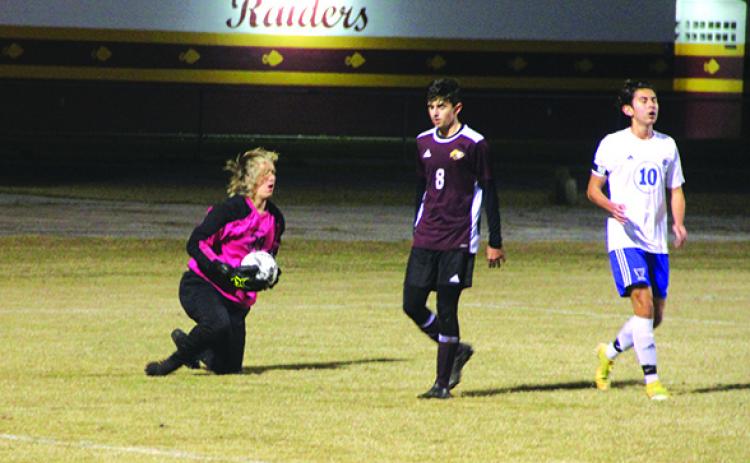 Crescent City High School boys soccer goalkeeper Jack Lewandowski secures the ball after making a point-blank save on Palm Coast Matanzas’ Andrew Alvarez (10) in the first half of Tuesday night’s game. In the middle is Crescent City’s David Newbold. (MARK BLUMENTHAL / Palatka Daily News)