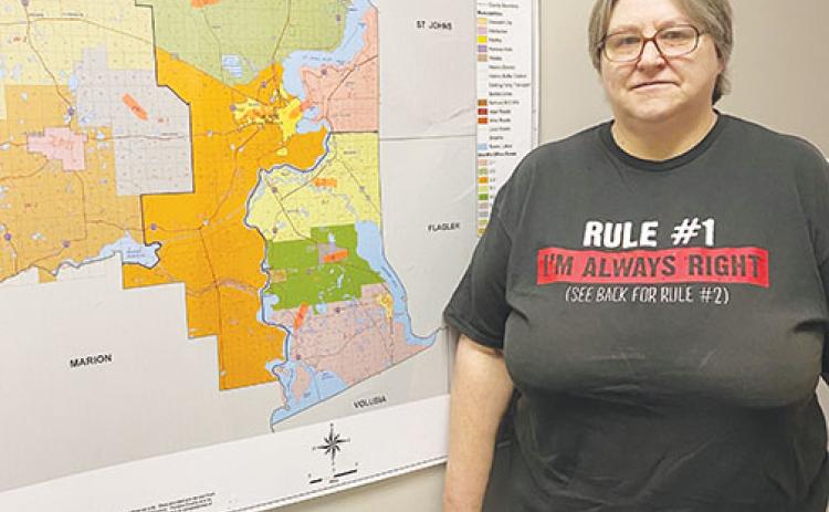 Volunteer Sue Hege stands next to a map of Putnam County last year as she prepared to start the 2020 Point in Time Count.