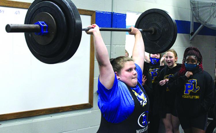 Interlachen’s unlimited division weightlifter Marissa McKibben delivers a successful 155-pound clean-and-jerk lift during last week’s Putnam County championship at Interlachen’s weightlifting room. (MARK BLUMENTHAL / Palatka Daily News)