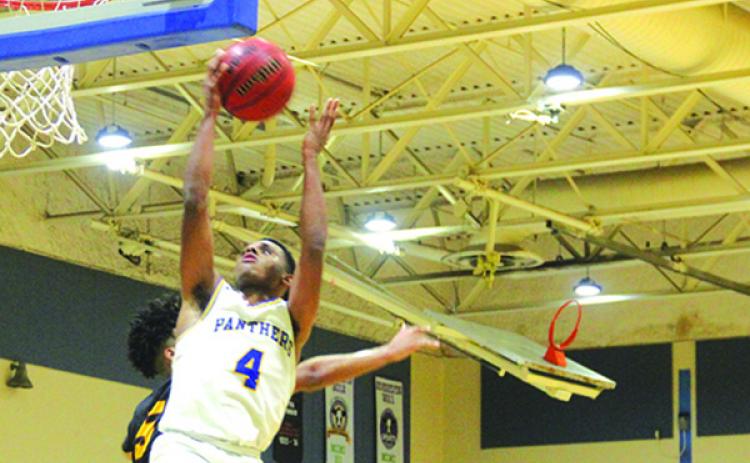 Palatka’s Jimmy Williams goes up for a shot against West Nassau’s Simeon Womock during Friday night’s game won by the visiting Warriors, 71-62. (MARK BLUMENTHAL / Palatka Daily News)