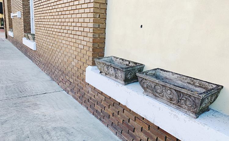 Window planters are returned to the Hotel James on Wednesday afternoon, more than 30 years after the hotel closed and the planters were given to some Palatka residents.