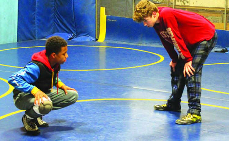 Palatka High School wrestlers Mikade Harvey (left) and Brandon Lewis take a break after battling with one another during Wednesday’s practice at Palatka High, the final practice in the wrestling practice room this season. (MARK BLUMENTHAL / Palatka Daily News)