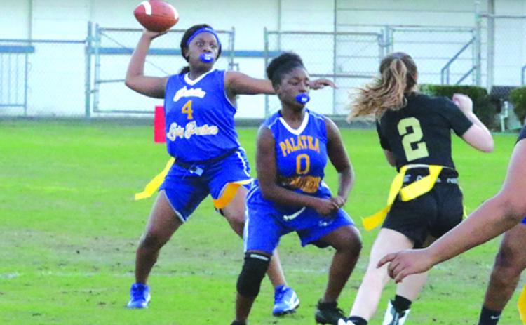 Palatka High School quarterback Chloe Dasher attempts to throw a pass as Zar’Kira Clark (0) blocks for her during the Panthers’ opening game of the season against St. Augustine on Thursday. (ANTHONY RICHARDS / Palatka Daily News)