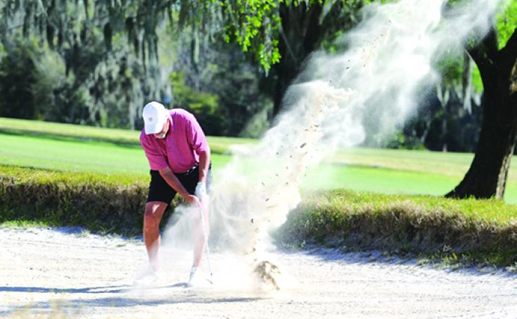 Jim Castagna from Sandy Spring, Maryland, hits out of a sand trap on the fifth hole during the Senior Azalea Amateur golf tournament at the Palatka Municipal Golf Club in Friday’s first round. (ANTHONY RICHARDS / Palatka Daily News)