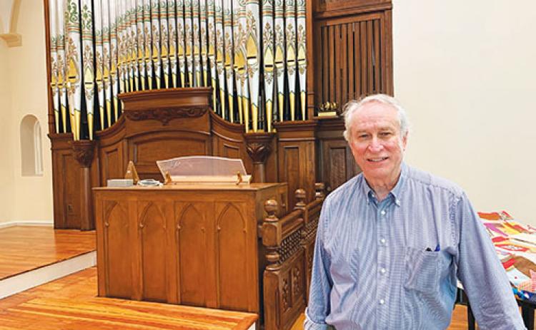 First Presbyterian Church Pastor Cliff Lyda stands Wednesday afternoon inside the revamped sanctuary, where the church’s organ, among other features and fixtures, has been refurbished.