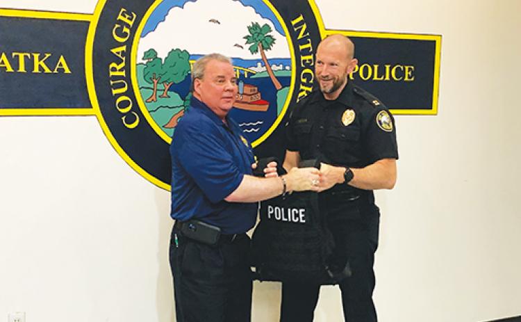 Palatka Police Department Capt. Matt Newcomb holds a vest the department received from InVestUSA President Mike Letts on Wednesday morning.