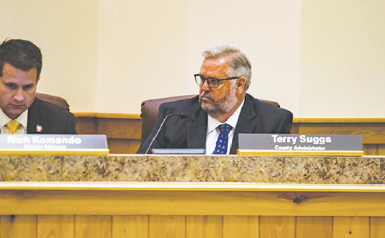 County Administrator Terry Suggs, right, listens to county commissioners during a meeting Tuesday morning.