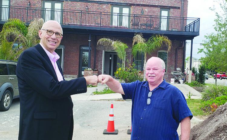 Robert Mills and Rusty Starr, co-chairmen of 1 Putnam’s Business Challenge Committee, stand in front of the building under renovation on the 100 block of Second Street in Palatka. 1 Putnam is presenting the Dr. Ifti Ahmad Spirit Awards to recognize county business owners.