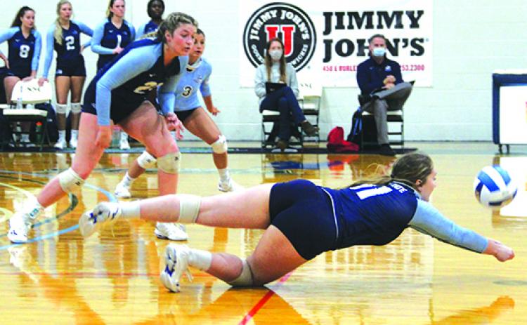 St. Johns River State College’s Tara English dives for a ball to keep possession alive during the second set of Thursday’s match against host Lake-Sumter. Emily Evans (21) and Dariana Luna (3) look on. (ANTHONY RICHARDS / Palatka Daily News)