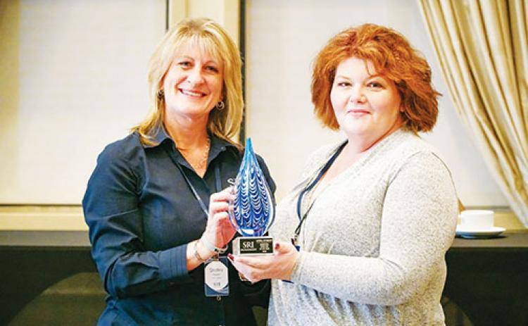 Shelley Kaiser, left, chief operating officer for SRI Management, presents Angela Wynkoop, executive director of Vintage Care Senior Living in Palatka, with the company’s 2020 Executive Director of the Year award earlier this year.