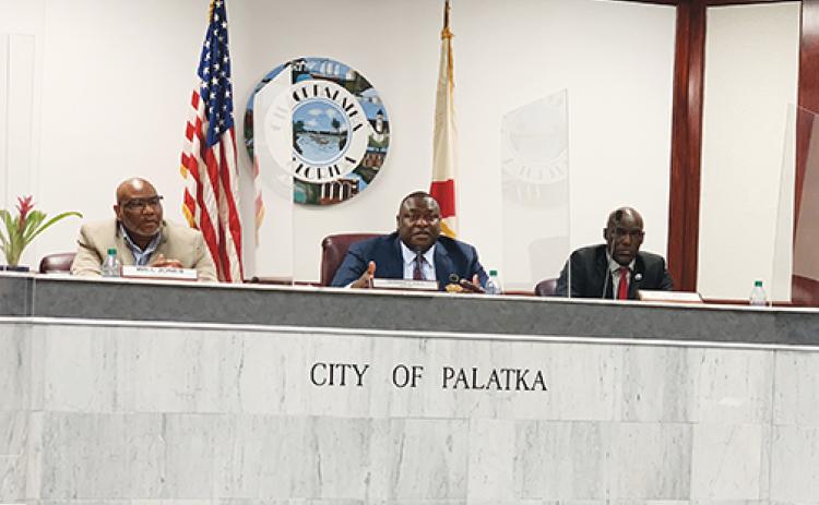 Palatka Mayor Terrill Hill, center, talks about the city’s mowing contract with the Florida Department of Corrections during Thursday’s Palatka City Commission meeting.