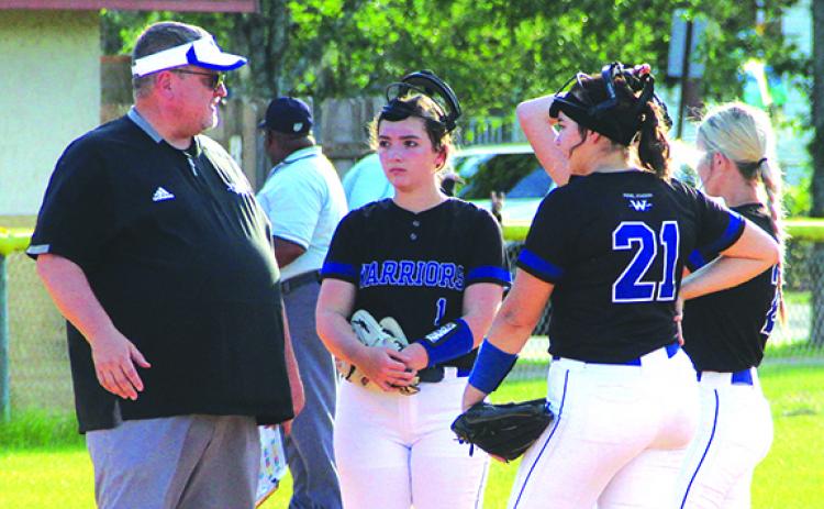 Peniel Baptist Academy softball coach Jeff Hutchins talks to his team during a pitching conference on April 6 against Interlachen. The Warriors host the District 4-2A tournament at Rotary Park next week. (ANTHONY RICHARDS / Palatka Daily News)
