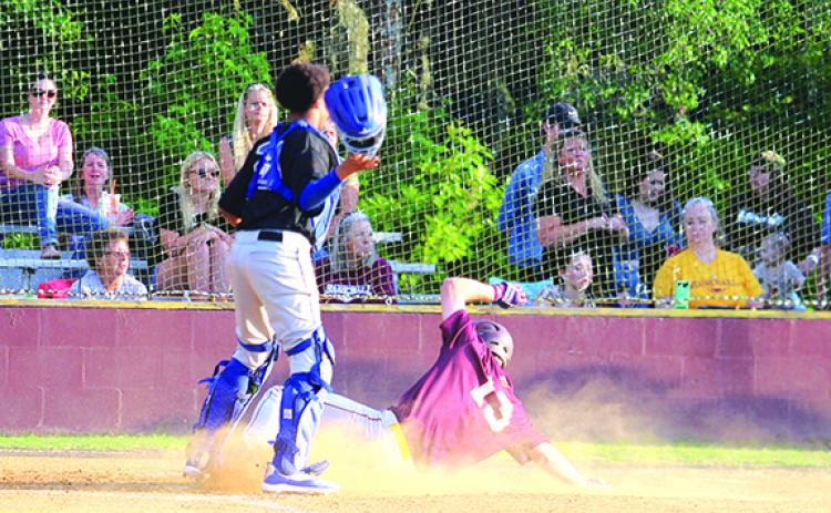Crescent City’s Dylan Hutchinson slides in safely on an infield hit during the third inning of Tuesday’s District 8-1A baseball game against Wildwood. Waiting on the play is Wildwood catcher Keegan St. Amant. (MARK BLUMENTHAL / Palatka Daily News)