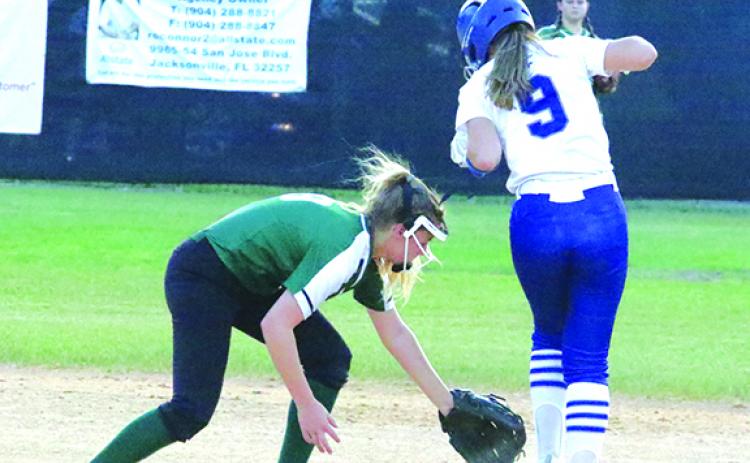 Peniel Baptist Academy’s Summer Langston steals second base in the fourth inning of Thursday’s District 4-2A softball championship game against Daytona Beach Father Lopez High. Shortstop Hannah Wilson tries to pick the ball up. (ANTHONY RICHARDS / Palatka Daily News)