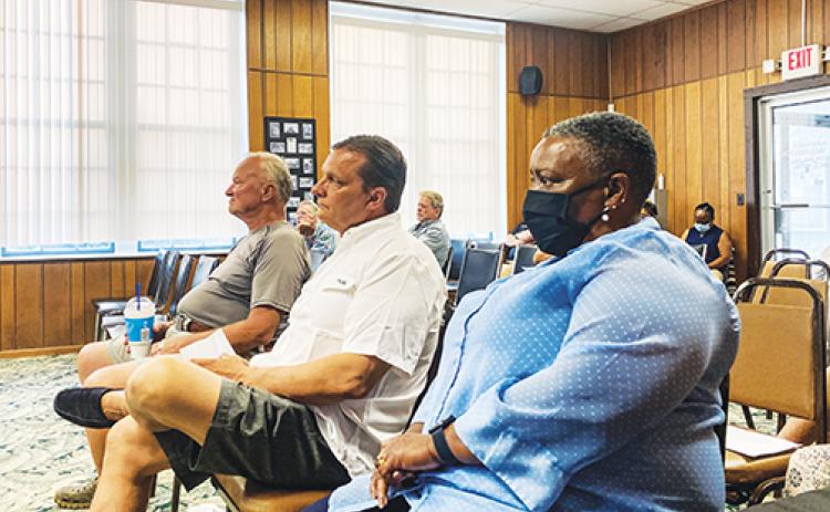 Welaka Town Council hopefuls, from left, Raymond Roerick, Michael Stanek and Kathy Washington listen as town officials explain the appointment process.