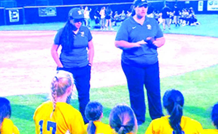 Palatka High School softball coach Brandi Malandrucco (left) listens as assistant coach Mindi Buckles talks to the team after Palatka lost to Eustis, 1-0, in the FHSAA Region 2-5A tournament in 2019. (MARK BLUMENTHAL / Palatka Daily News)