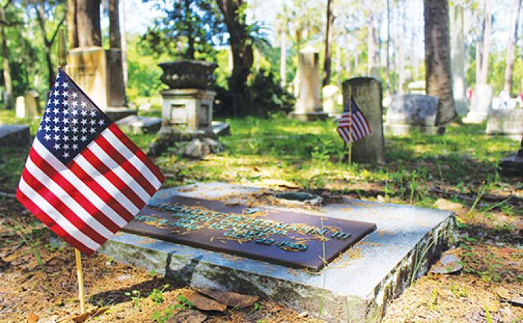 An American flag is placed at the gravesite of a U.S. military veteran.