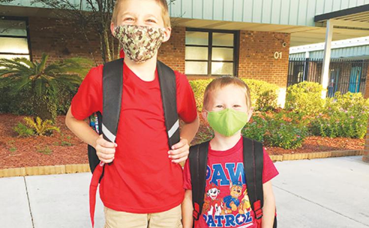 Students wearing masks ring in the first day of the 2020-2021 school year in August, but masks will be optional in school district buildings starting in the summer and continuing through next school year.