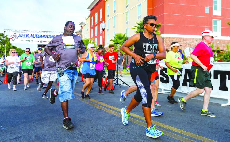 Runners take off from the start of the 2019 Beck 5K run in downtown Palatka. (Daily News file photo)