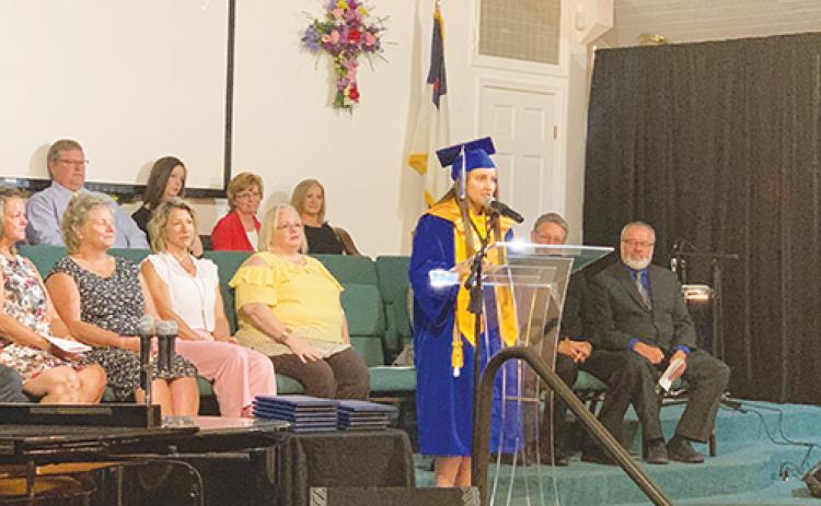 Peniel Baptist Academy valedictorian Brianna Allender addresses fellow graduates and their families during the school’s graduation ceremony Saturday.
