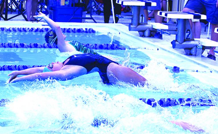 Putnam Sharks swimmer Abby Coulliette swims to victory in the 50-yard girls 15-and-over backstroke during Saturday’s home opener at the Putnam Aquatic Center. (ANTHONY RICHARDS / Palatka Daily News)